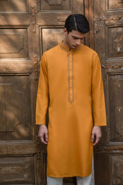 man wearing a luxury ochre yellow kurta for men with hand-embellished beadwork