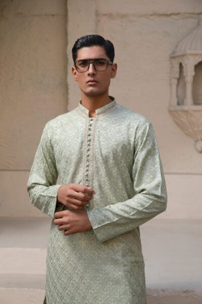 Mist Green Kurta for Men, Sage Green Designer Kurta, All-Over Hand-Embroidered Kurta, Luxury Mist Green Menswear, Sculpted Imperial Fit, Tapered Fit Men’s Kurta, Tailored Ethnic Silhouette, High-Fashion Wedding Wear 2026, Groom’s Nikah Kurta, Elite Summer Festive Wear, Artisan Threadwork Couture, Handcrafted Floral Embroidery, Bespoke Mist Green Outfit, Unique Designer Ethnic Wear, Premium Pastel Kurta for Men, Sophisticated Mint Green Fashion, Statuesque Men's Silhouette, Romantic Green Wedding Attire, Luxurious Hand-Finished Kurta, Modern Heritage Menswear.