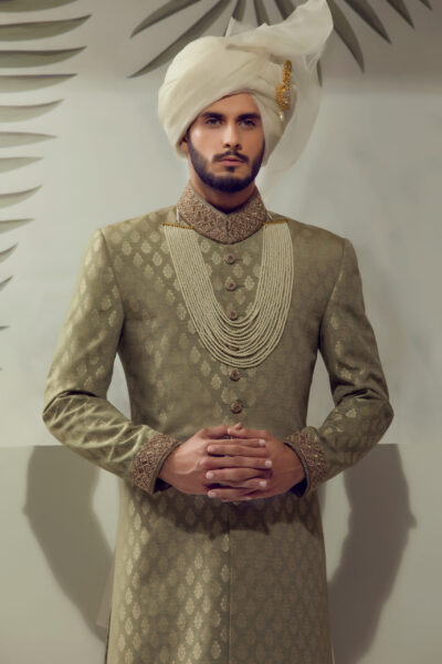 man wearing SAGE GREEN SHERWANI for groom WITH MATCHING TURBAN on his wedding day of naushemian by nauman arfeen
