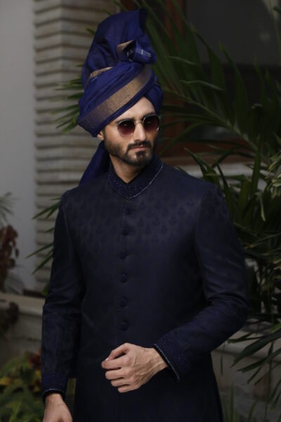 man wearing BLUE SHERWANI for groom WITH MATCHING TURBAN designed by naushemian by nauman arfeen on his wedding day