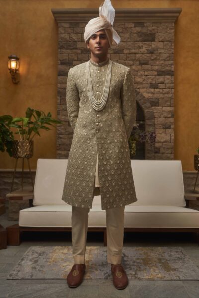 man wearing MINT GREEN SHERWANI for groom PAIRED WITH BEIGE INNER SUIT AND WHITE TURBAN on wedding day of naushemian by nauman arfeen
