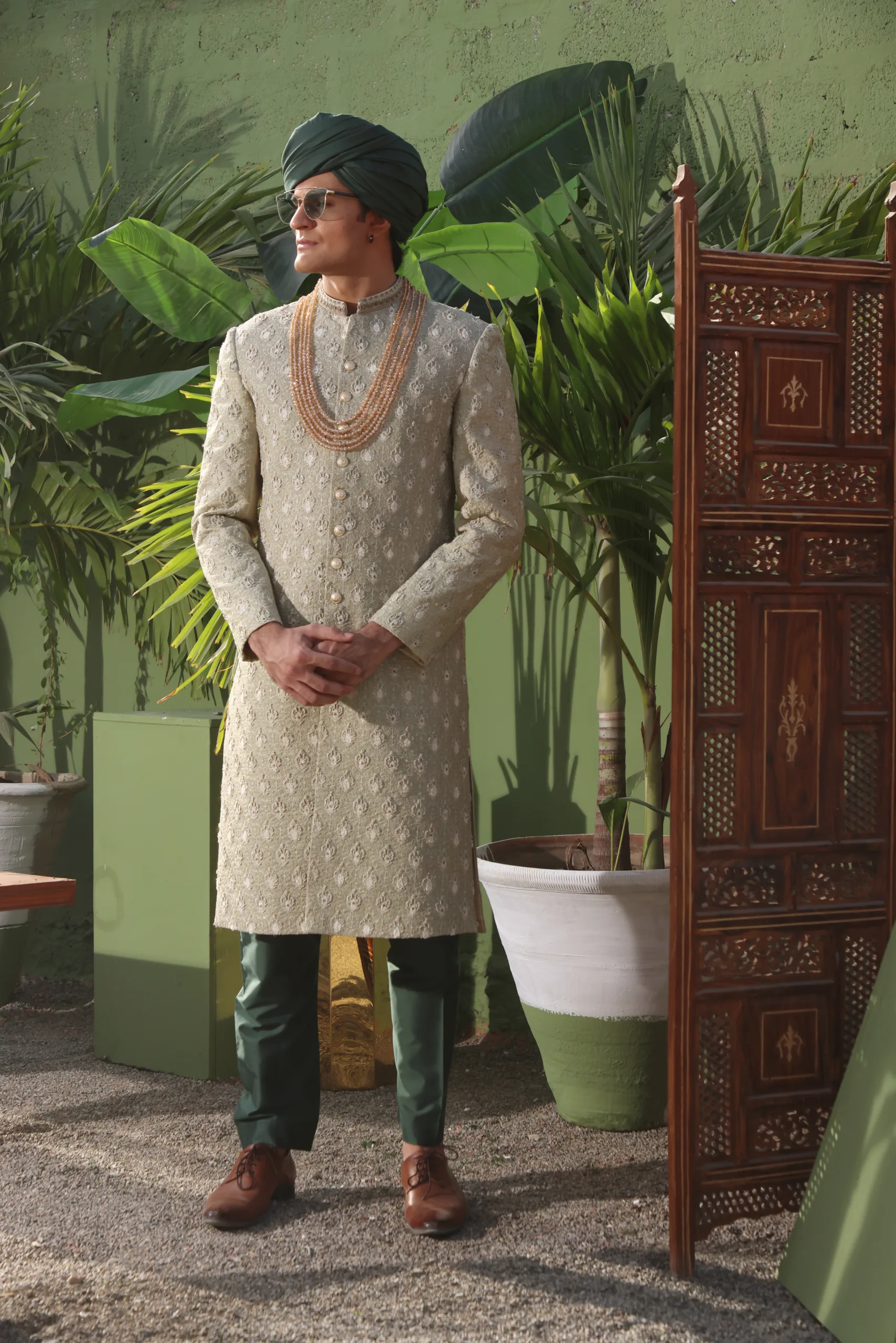 GREEN SHERWANI man wearing ALOE GREEN SHERWANI for groom PAIRED WITH BASIL GREEN INNER SUIT AND TURBAN on wedding day designed by naushemian by nauman arfeen