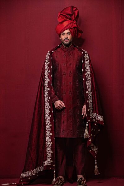 man wearing Dark MAROON SHERWANI for groom PAIRED WITH MATCHING INNER SUIT, SHAWL AND TURBAN designed by naushemian by nauman arfeen on wedding day
