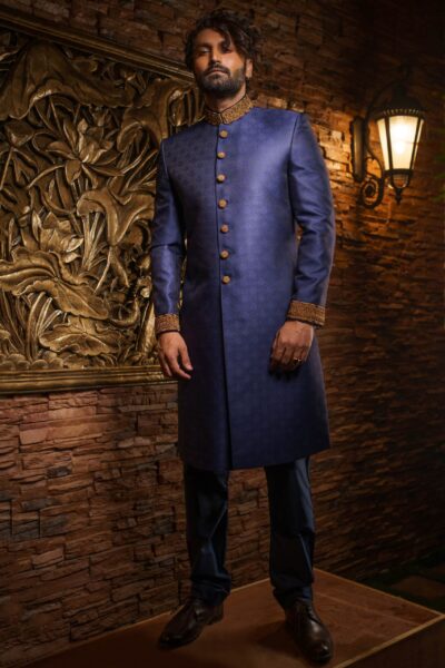 man wearing INDIGO BLUE SHERWANI for groom PAIRED WITH MATCHING INNER SUIT on his wedding day designed by naushemian by nauman arfeen