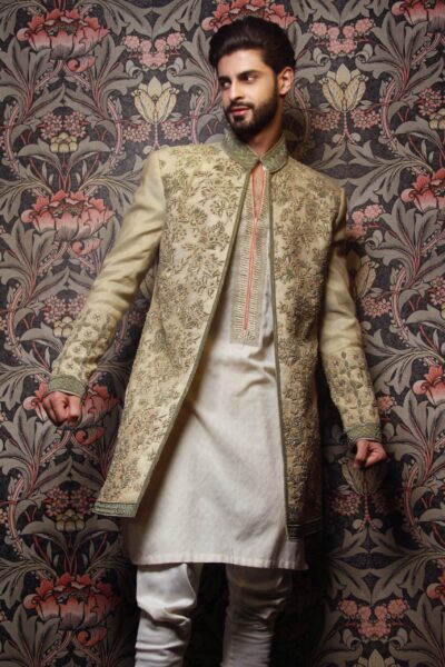 man wearing ECRU GREEN SHERWANI for groom PAIRED WITH COSMIC LATTE INNER SUIT designed by naushemian by nauman arfeen on wedding day