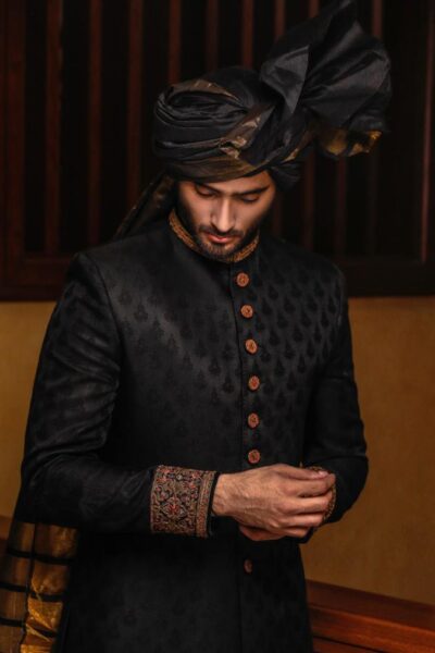 man wearing DEEP BLACK SHERWANI for groom PAIRED WITH MATCHING INNER SUIT, SHAWL AND TURBAN