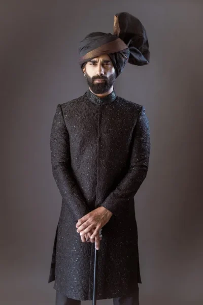 man wearing black sherwani for groom WITH MATCHING INNER SUIT AND TURBAN for wedding naushemian by nauman arfeen