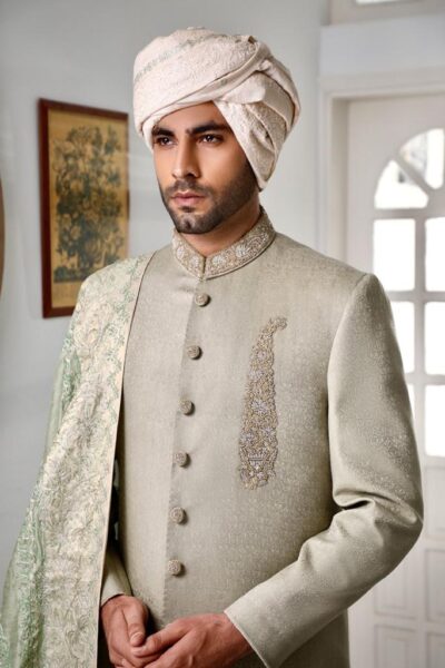 man wearing LAUREL GREEN SHERWANI WITH MATCHING INNER SUIT AND SHAWL PAIRED WITH BEIGE TURBAN on his wedding day designed by naushemian by nauman arfeen