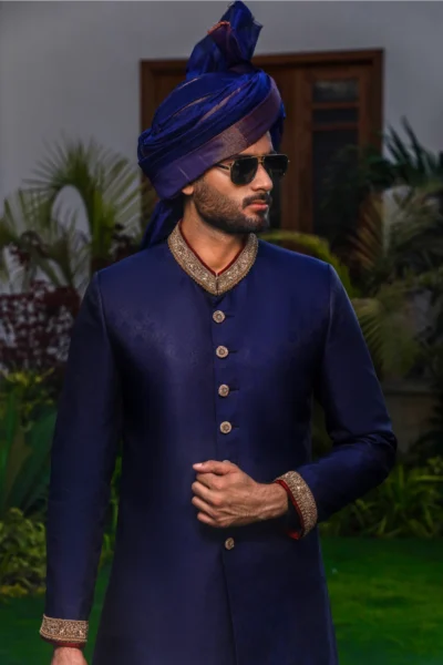 man wearing NAVY BLUE SHERWANI for groom PAIRED WITH MATCHING INNER SUIT, SHAWL AND TURBAN on his wedding day naushemian by nauman arfeen