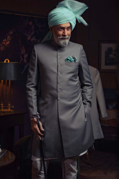 man wearing CORAL BLACK SHERWANI for father of bride or father of groom WITH WHITE INNER SUIT PAIRED WITH LIGHT BLUE TURBAN designed by naushemian by nauman arfeen on wedding day