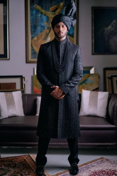 Man wearing ROCK BLACK SHERWANI PAIRED WITH MATCHING INNER SUIT, TURBAN AND SHAWL Trending Sherwani Designs - Pakistani Black Sherwani for men - designer sherwani for wedding naushemian by nauman arfeen
