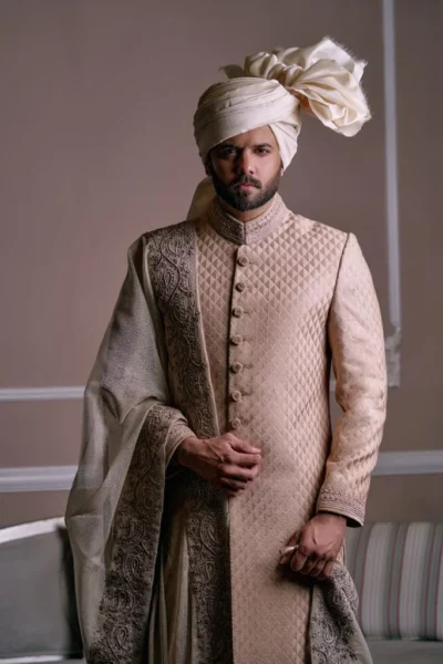 Man wearing Light gold Sherwani for groom with matching turban wedding sherwani for groom, sherwani style, black sherwani, best fashion designer sherwani for groom in Pakistan