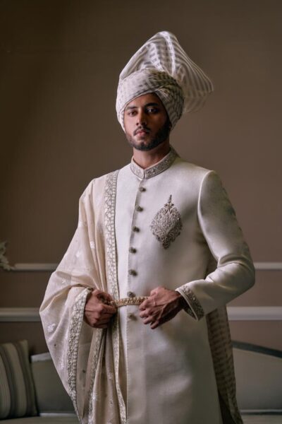 man wearing white sherwani for groom of naushemian by nauman arfeen best sherwani set - designer sherwani buy online - best mens wear designer