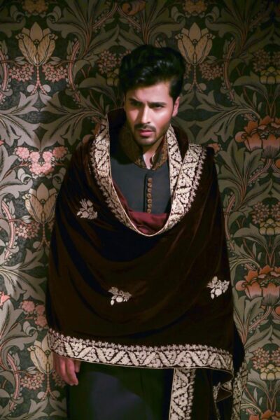 man wearing SLATE BLACK SHERWANI for groom WITH MATCHING INNER SUIT PAIRED WITH MAROON VELVET SHAWL of naushemian by nauman arfeen