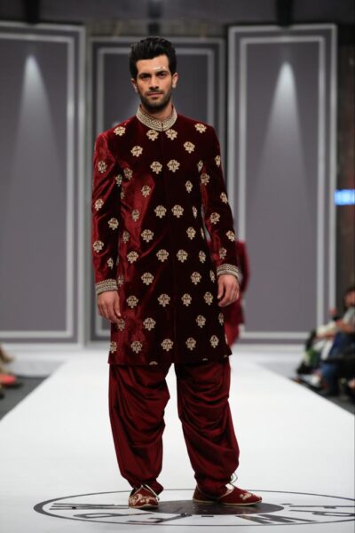 man wearing MAROON SHERWANI for groom PAIRED WITH MATCHING INNER SUIT, SHAWL AND TURBAN designed by naushemian by nauman arfeen