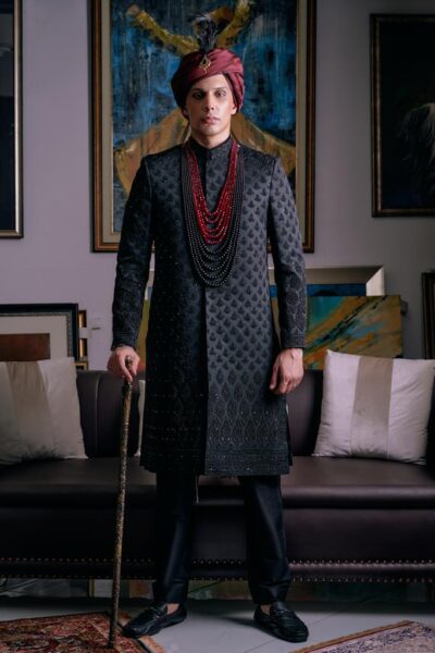 man wearing FROST BLACK SHERWANI WITH MATCHING INNERSUIT PAIRED WITH MAHOGANY TURBAN of naushemian by nauman arfeen