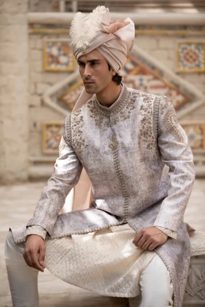 Majestic ivory white sherwani with heavy embroidery on the neck, collar, and shoulders.