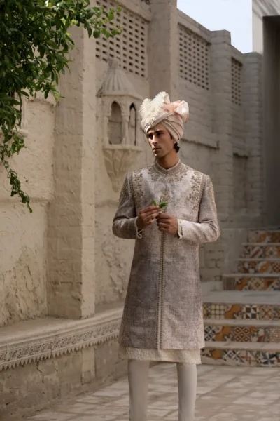 Majestic ivory white sherwani with heavy embroidery on the neck, collar, and shoulders.