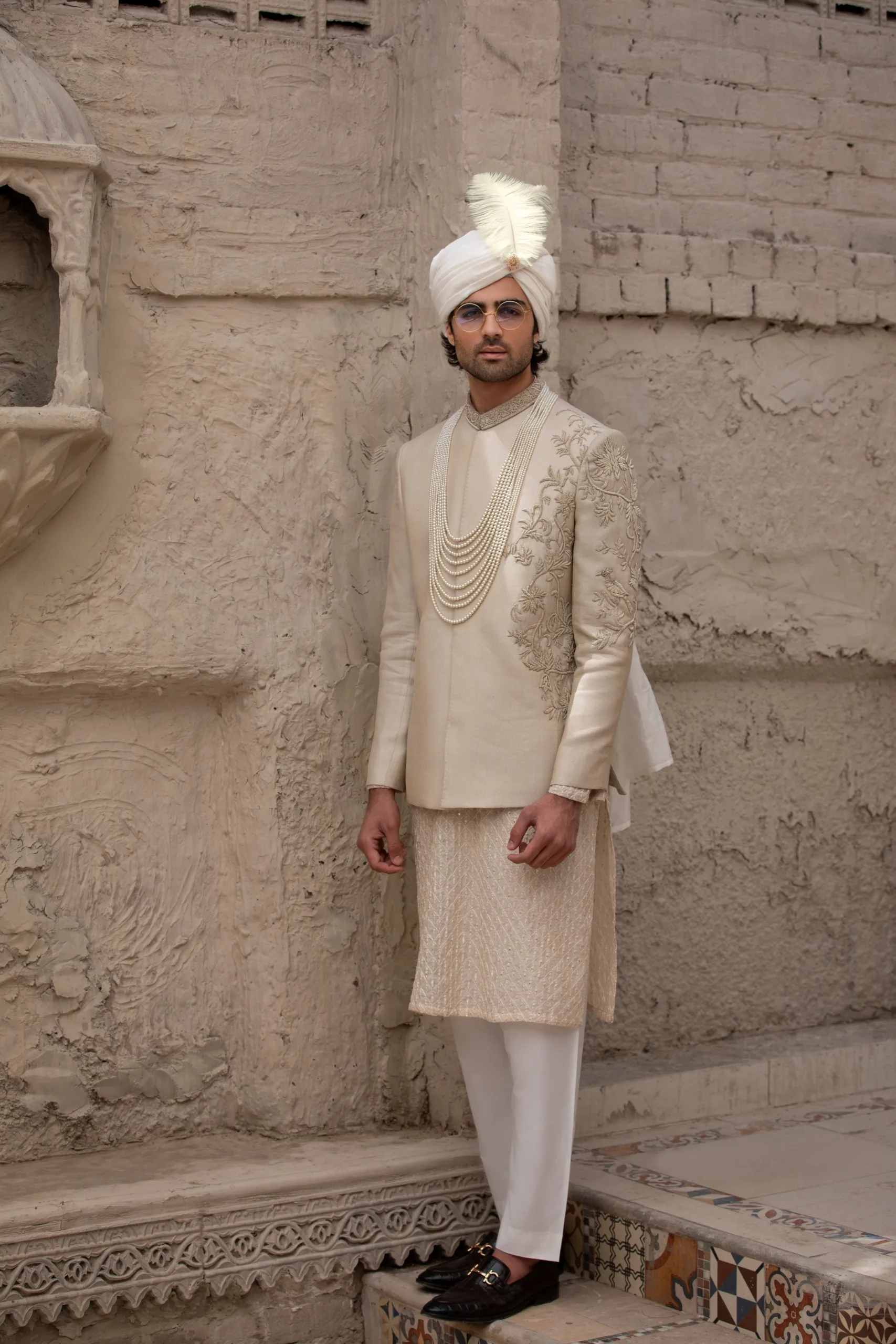 Stunning beige prince coat with intricate half embroidery on the front and full collar embroidery. Stunning beige prince coat with intricate half embroidery on the front and full collar embroidery.