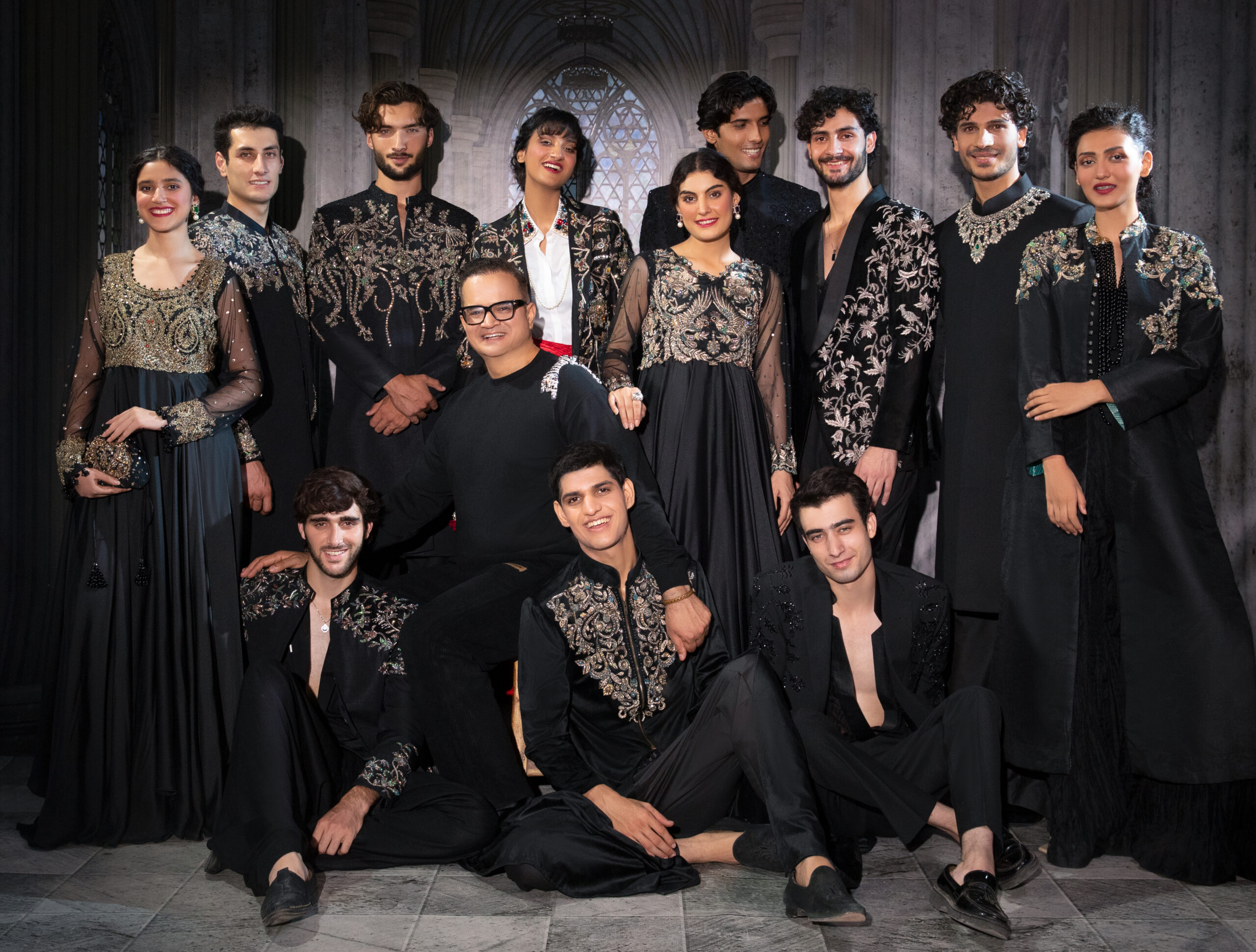 Best designer in karachi C76A5516 Astral Heirloom Black Embellished Couture Sherwani Set featuring ornate hand embroidery across the shoulders and chest, embroidered cuffs, structured band collar, tailored black trousers, and embellished upper-back detailing.