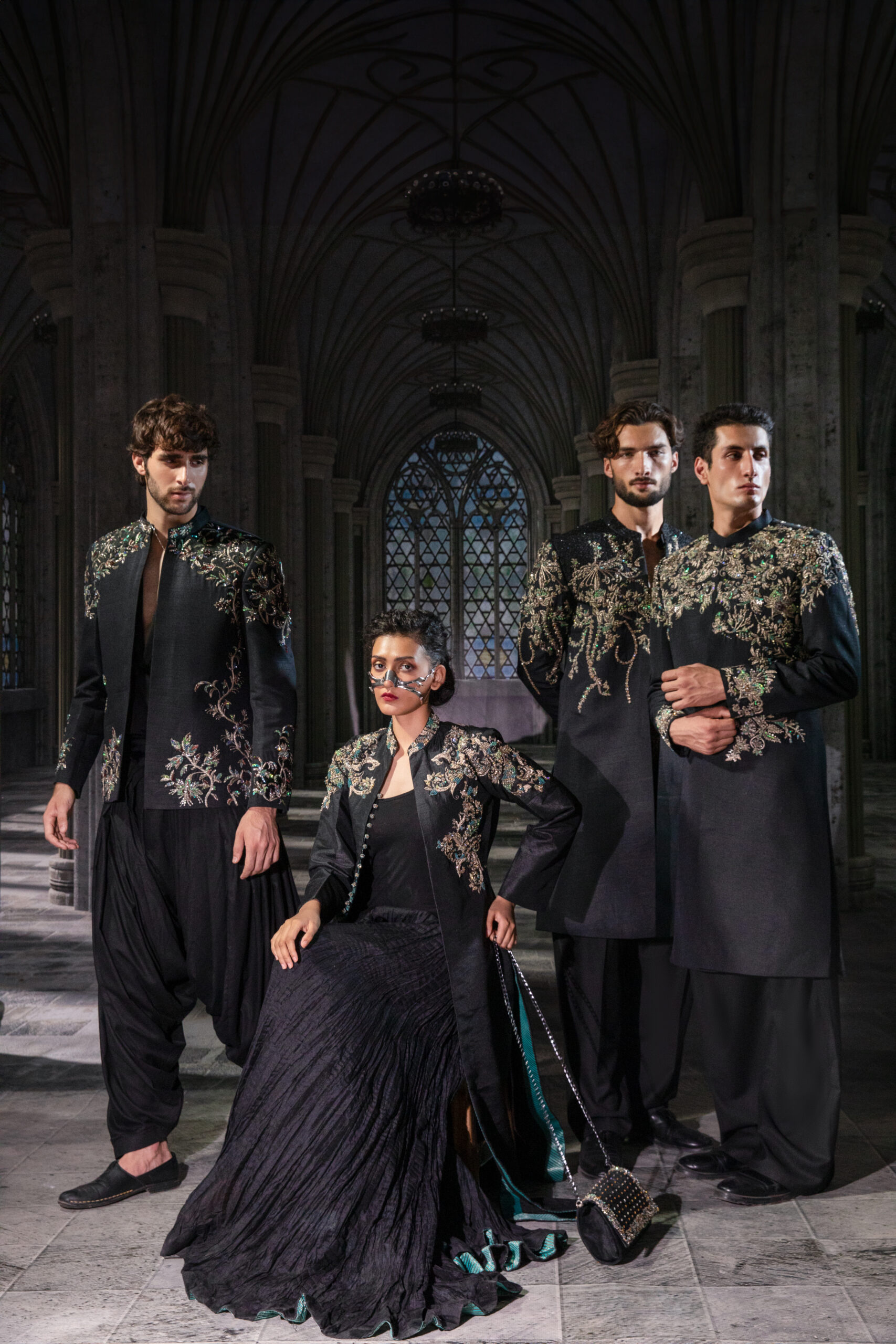 C76A5556 Noir Étoilé Black Embellished Couture Coat Gown Set featuring a floor-length black coat with intricate crystal embroidery on the shoulders, high neckline, hand embellishments, textured flowing gown, and embellished back detailing.