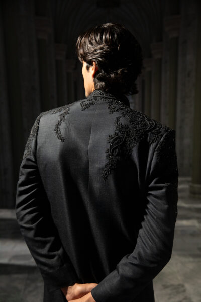 Naushemian jet black sherwani with tonal embroidery and beadwork, tailored trousers, and regal silhouette ÉTOILE collection by Nauman Arfeen is a story chosen to tell through fabric, craftsmanship, light and emotion. The Genesis is the first chapter of a five-part journey
