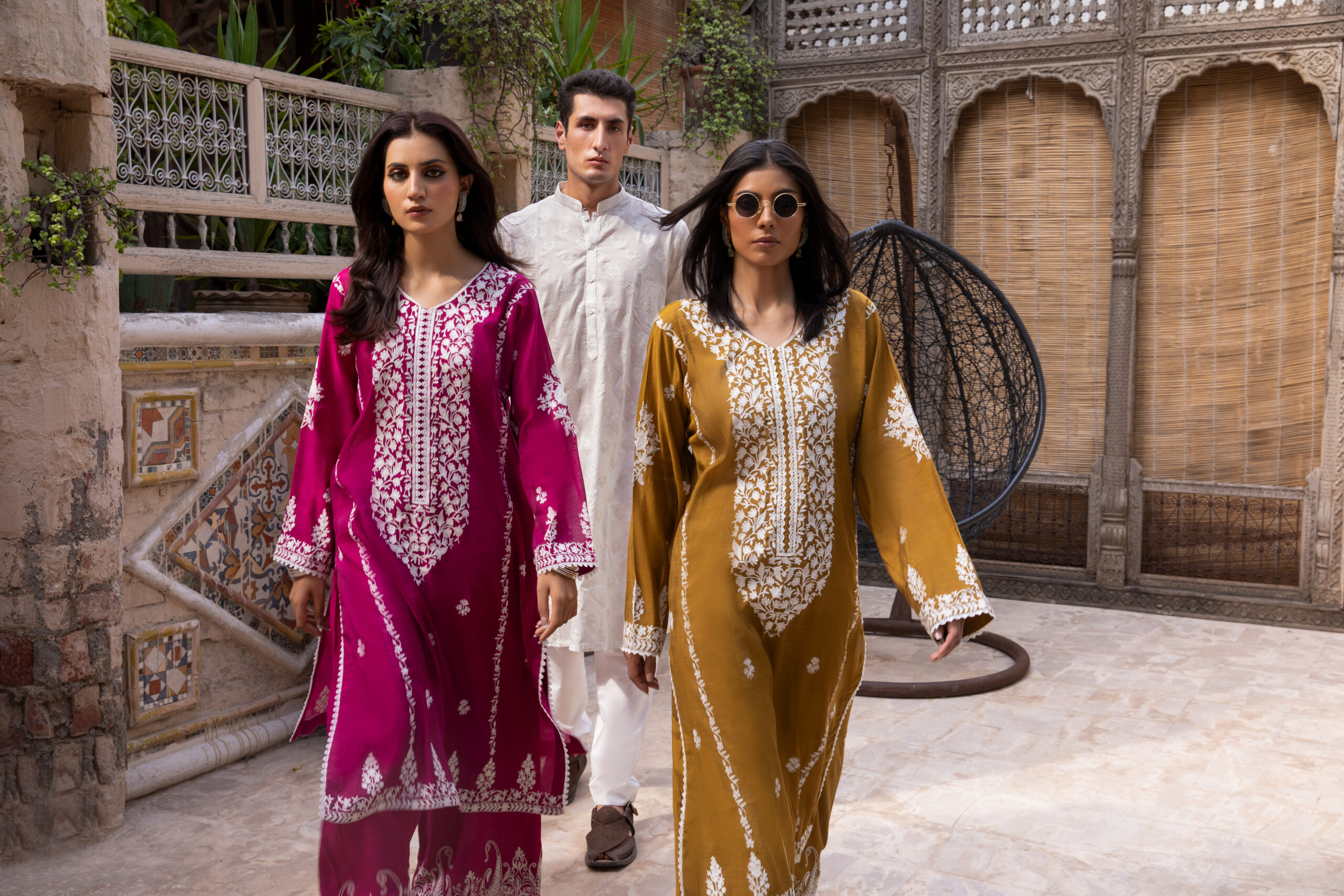 C76A6945 Rich mustard-coloured kurta Intricate white floral embroidery Elegant V-shaped embroidered neckline Full-length long kurta silhouette Embroidered sleeves and statement cuffs Scattered floral motifs on the kurta Detailed embroidered side borders Ornate embroidered kurta hem Wide-leg trousers Embroidered trouser hem Coordinated two-piece ensemble Suitable for festive and cultural occasions Elegant option for daytime and evening gatherings Contemporary silhouette with traditional detailing