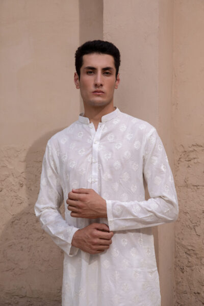 White embroidered men's kurta pajama with tonal motifs and matching white pajama