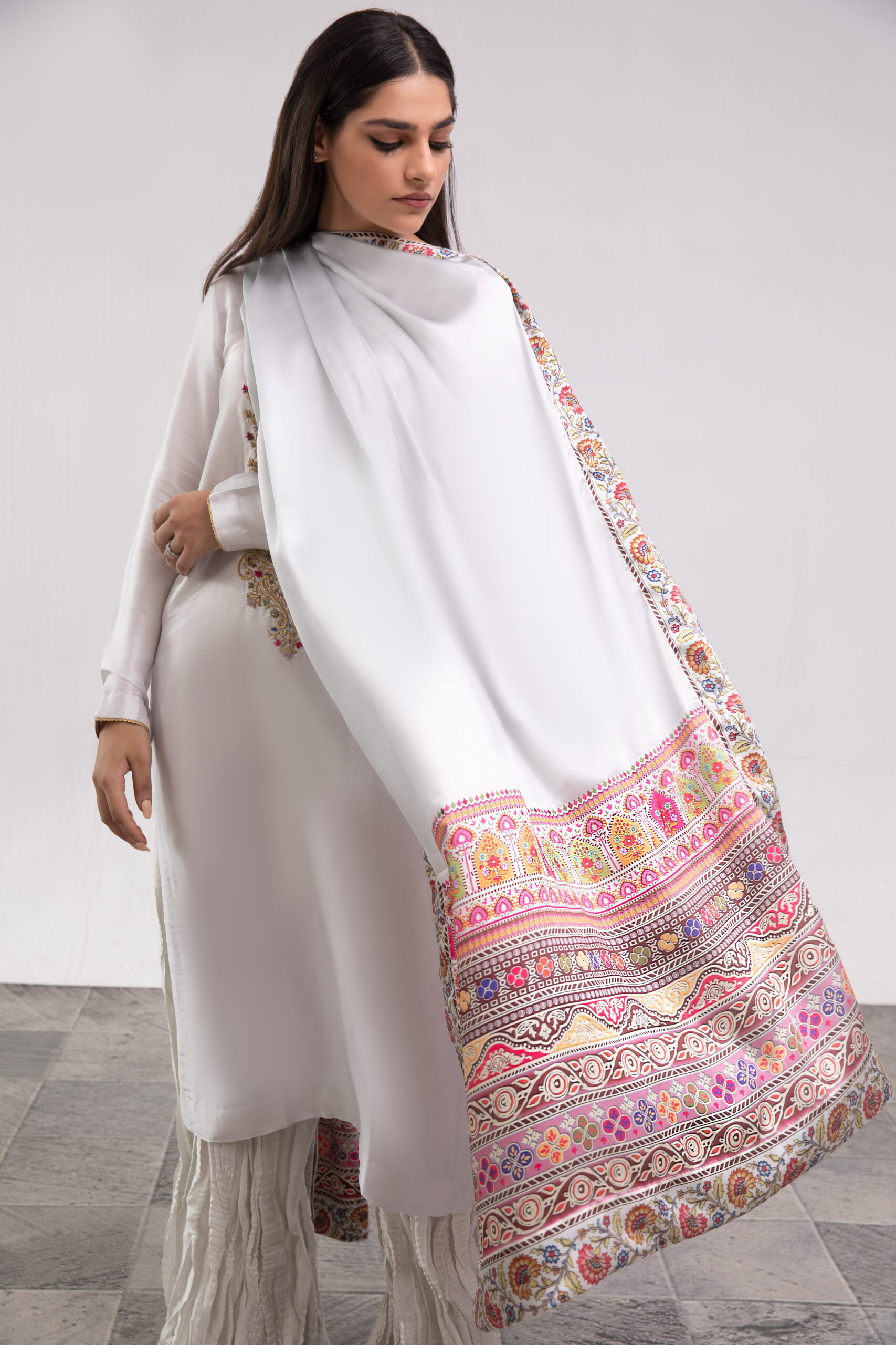 Buy the White Silk Ladies Dress online. Features a multi-colored embroidered silk shirt, ruffled garara, and printed dupatta. Shop luxury wear today!