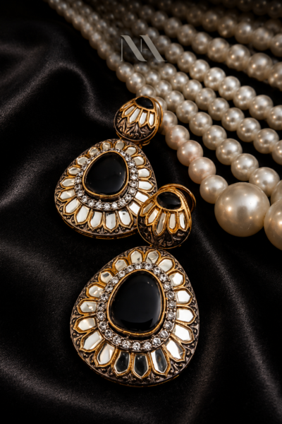 Antique gold drop earrings with large black onyx stone and kundan mirror work. Regal statement jewelry
