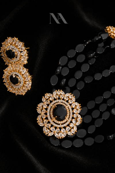 Midnight bead necklace set with black onyx and crystal starburst pendant. Includes matching gold stud earrings