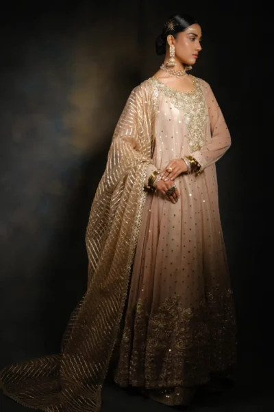 bride wearing Peach Wedding Gown with heavy embroidered gold neck work, mirror work on the full frock, and a heavily embroidered dupatta with floral lace work and heavy borders.