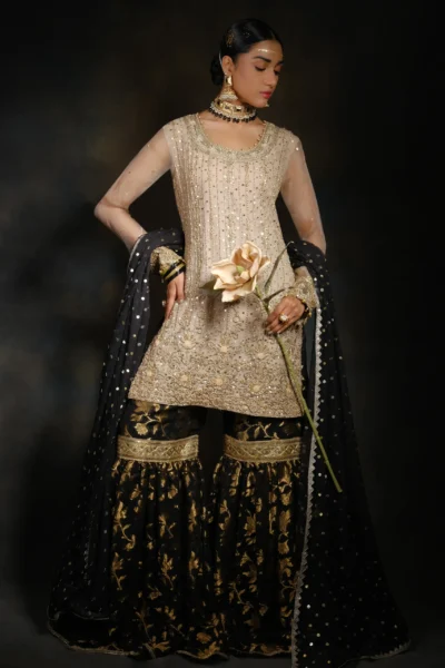 Lovely Gold Gharara set featuring heavy floral embroidery, mirror work, stones, lace work, and bead work.