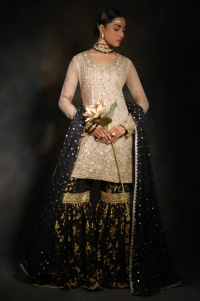 Lovely Gold Gharara set featuring heavy floral embroidery, mirror work, stones, lace work, and bead work.