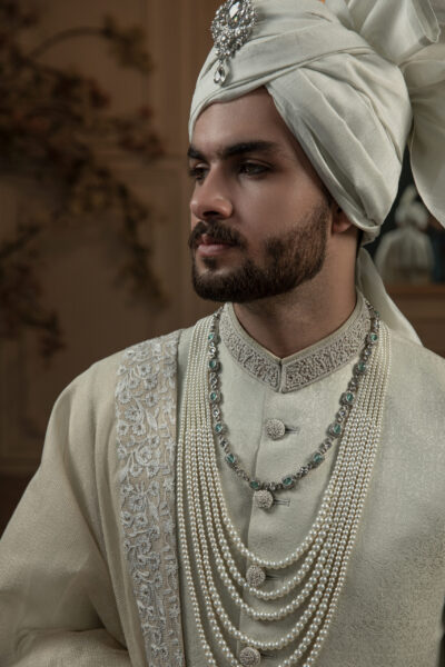 Sovereign Weave Sherwani for Groom in self-woven fabric with hand embroidery on collar, sleeves, and buttons, paired with matching inner suit, turban, and masoori net shawl with embellished border