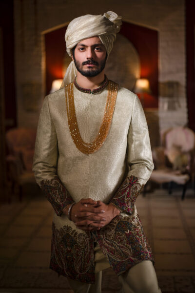 Luxury Hand-Woven WHITE SHERWANI Groom Nauman Arfeen, Pearl Sheen Self-Weave Sherwani Pearl Mala, Multi-Color Embroidery on Cuff and Hem