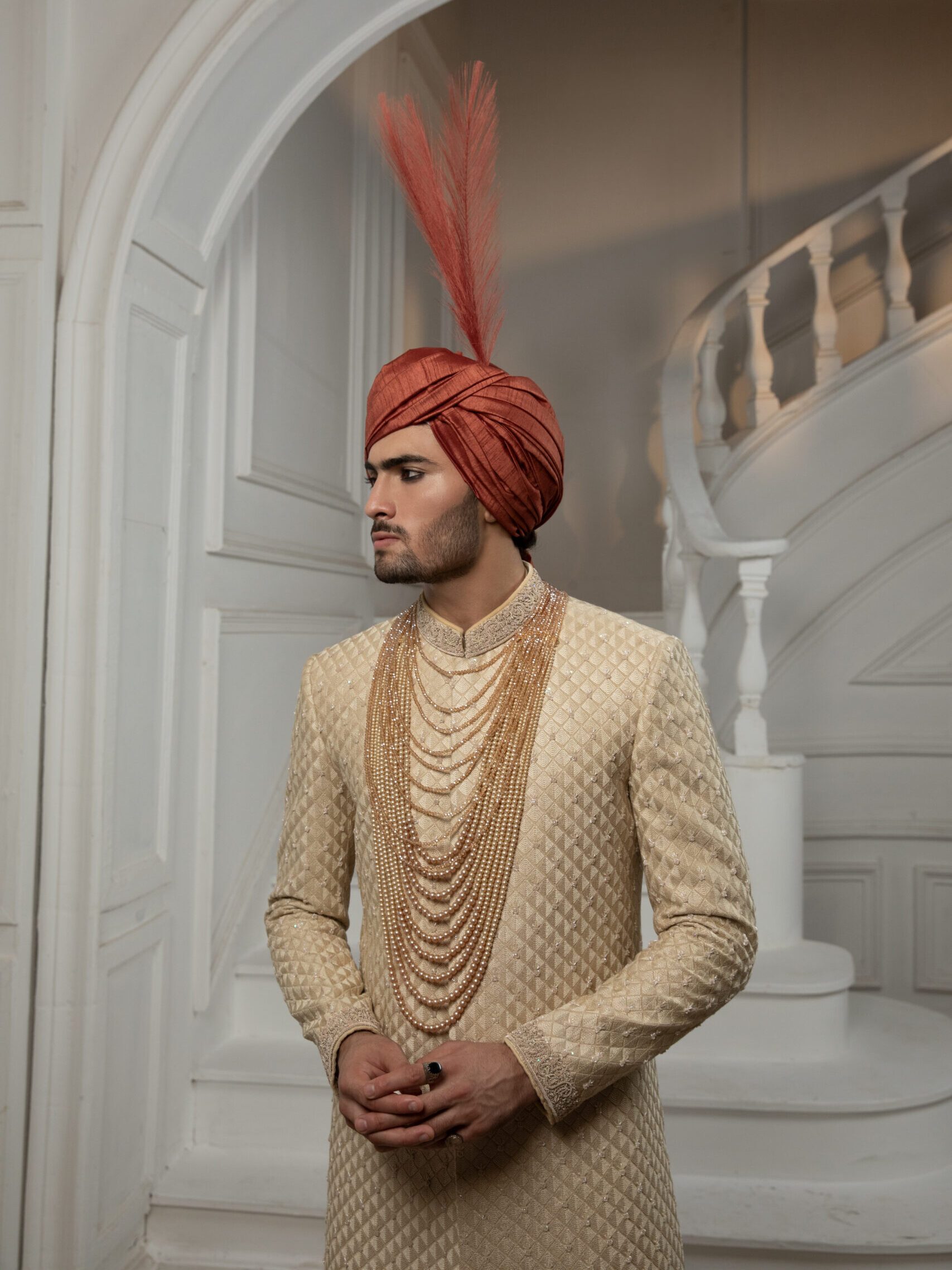 _F1A2576 Royal Sherwani for Groom 2025 by Nauman Arfeen – Luxury Pakistani Wedding Sherwani in traditional heritage design with embroidery and prince coat styleÉlysian Luxe Sherwani for Groom in light gold with hand embroidery on collar and sleeves, back motif, matching inner suit and turban – luxury Pakistani wedding sherwani