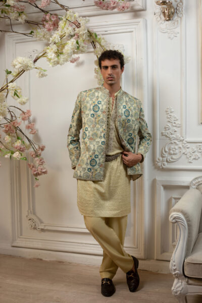 he Stellar Radiance Prince Coat in digital print raw silk, adorned with sequins and jewel crystal handwork. Paired with a fully embroidered kurta, perfect for Pakistani weddings.