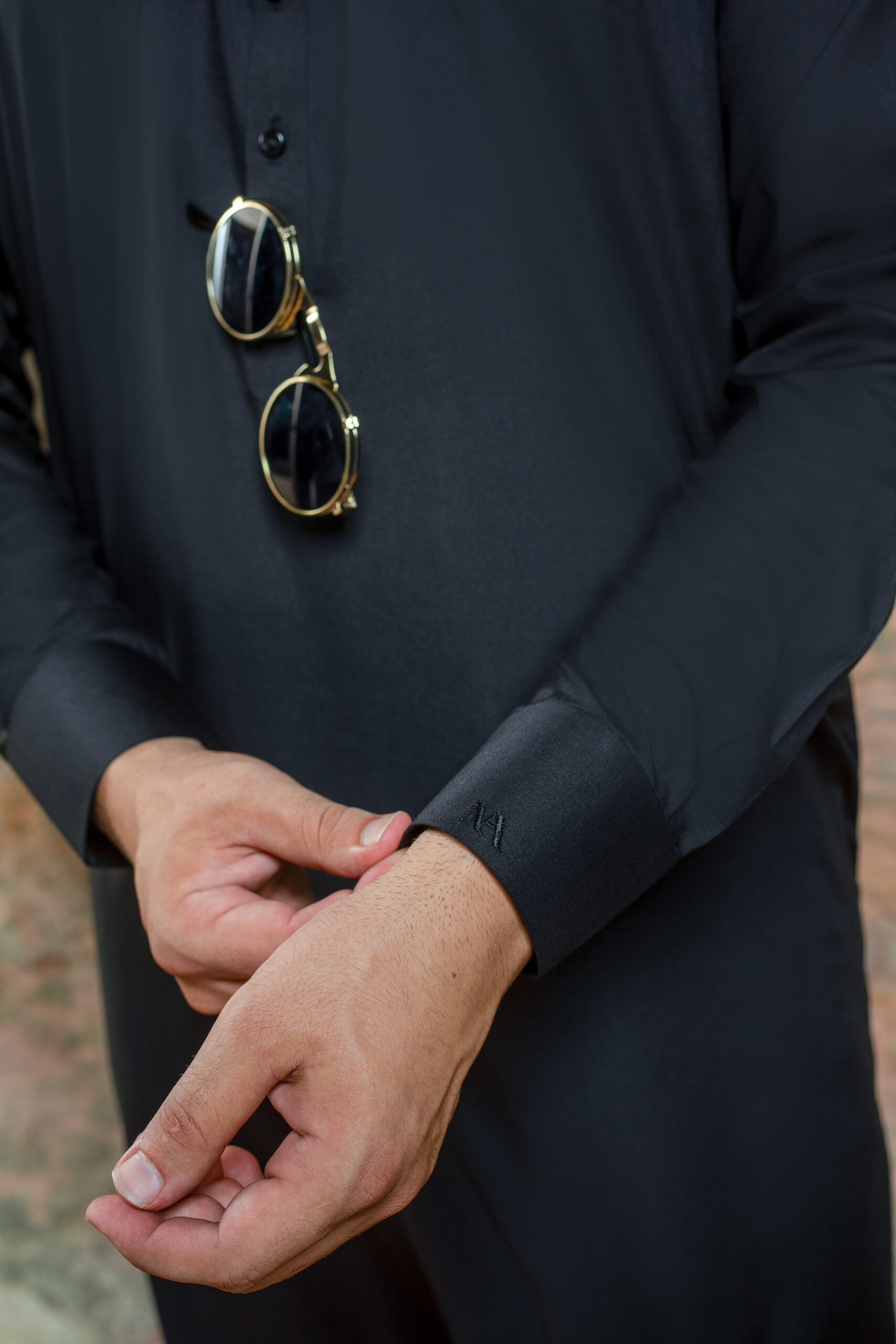 _F1A2846 Close-up of Premium Black Kurta cuff and fabric detail. Showing texture of Band Collar Kurta and refined cuff of Luxury Black Shalwar Kameez by Naushemian.