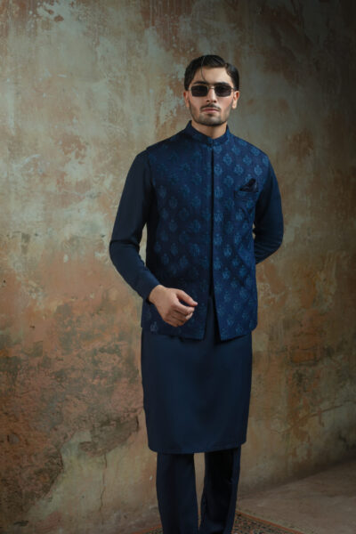 Luxe Blue Raw Silk Waistcoat by Naushemian by Nauman Arfeen. Model wearing formal Designer Raw Silk Nehru Vest with Thread Motifs