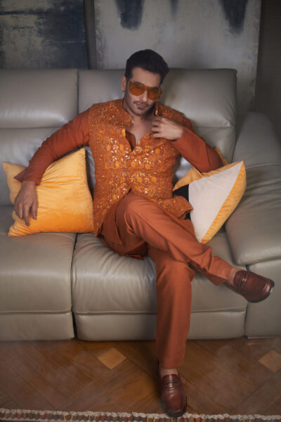 Stand out at Mehendi and festive celebrations with this vibrant orange waistcoat, highlighted with elegant mirror embroidery for a radiant look