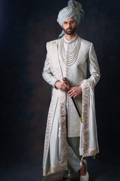 Luxury light green wedding sherwani for groom with pearl embroidery, thread handwork, and designer tailoring by Nauman Arfeen – perfect for South Asian weddings.
