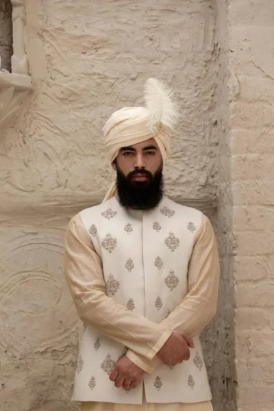 luxurious off-white waistcoat, featuring intricate motifs on the front and back
