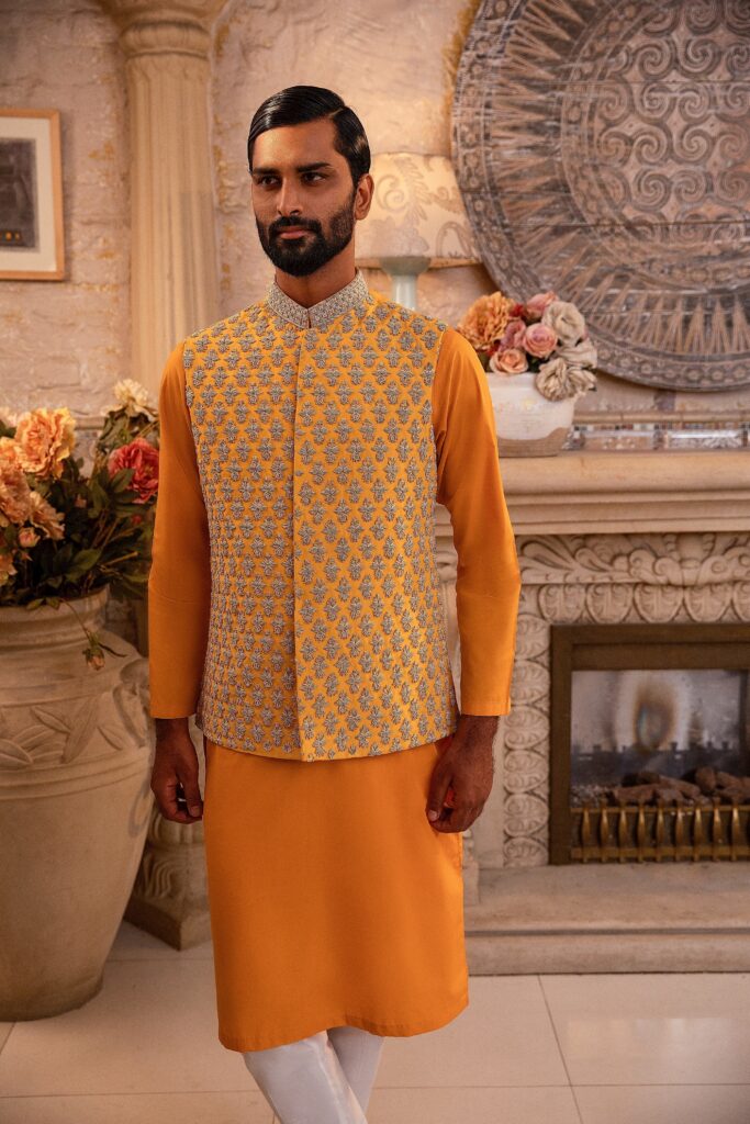 man wearing canary yellow waistcoat designed by nauman arfeen on his mehendi event paired with matching kurta pajama