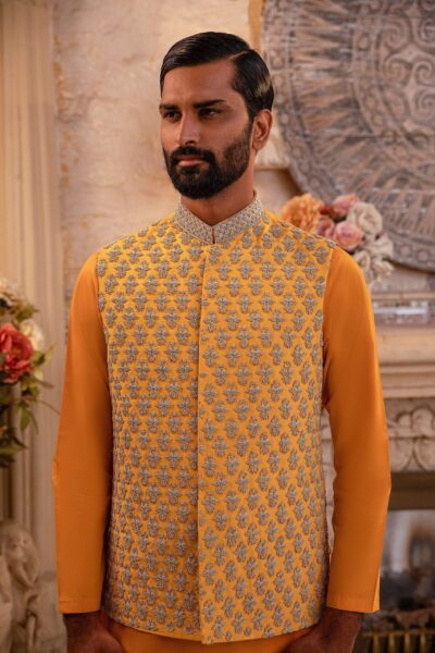 Man wearing Saffron Gold Mirror-Embroidered Waistcoat for men for mehendi wedding event by naushemian by nauman arfeen