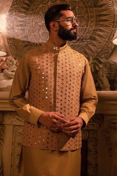 Man wearing Saffron Gold Mirror-Embroidered Waistcoat for men for mehendi wedding event by naushemian by nauman arfeen