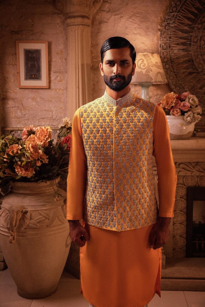 man wearing canary yellow waistcoat designed by nauman arfeen on his mehendi event paired with matching kurta pajama