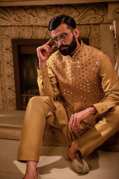 Man wearing Saffron Gold Mirror-Embroidered Waistcoat for men for mehendi wedding event by naushemian by nauman arfeen